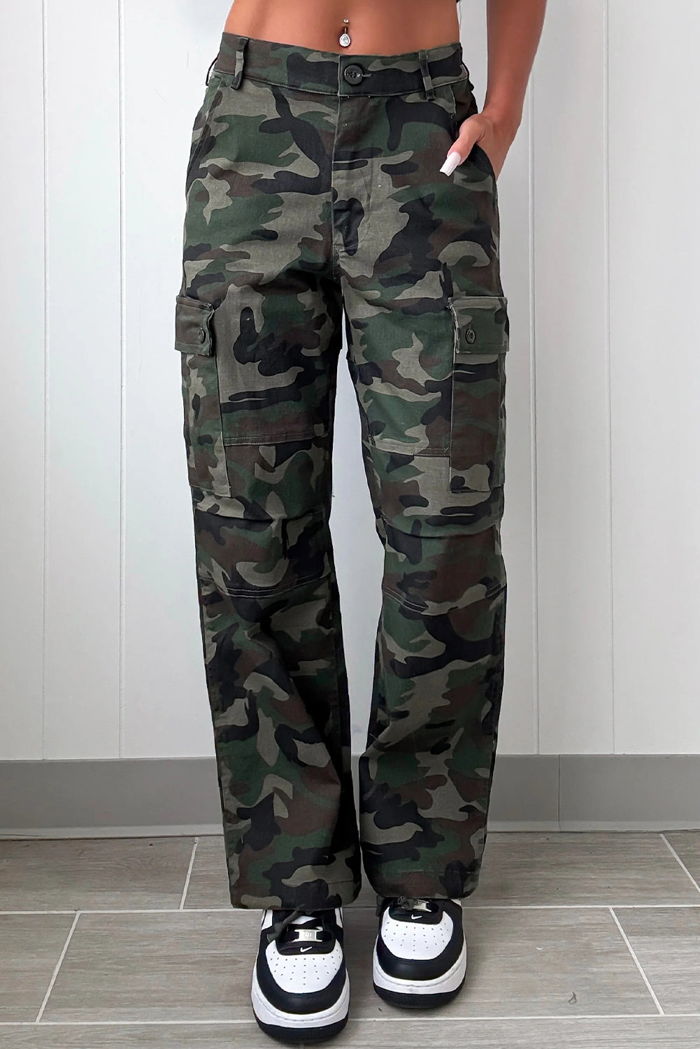 stylish women's green camouflage loose fit pants with button flap pockets and trendy patch accents made for easy styling and wardrobe coordination,