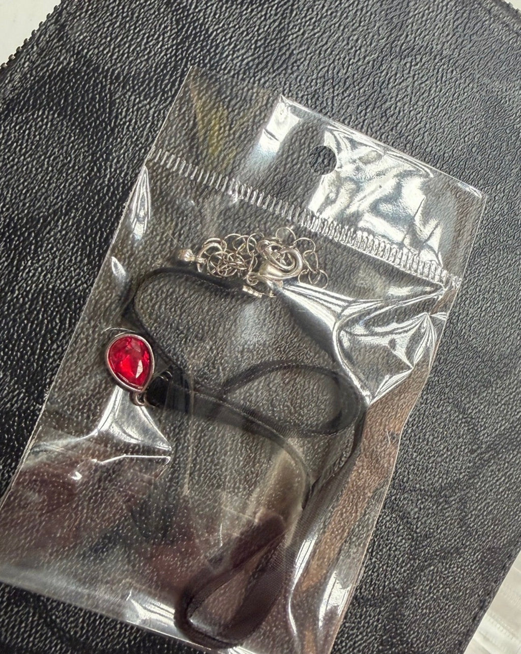 Charm choker necklace with red teardrop pendant