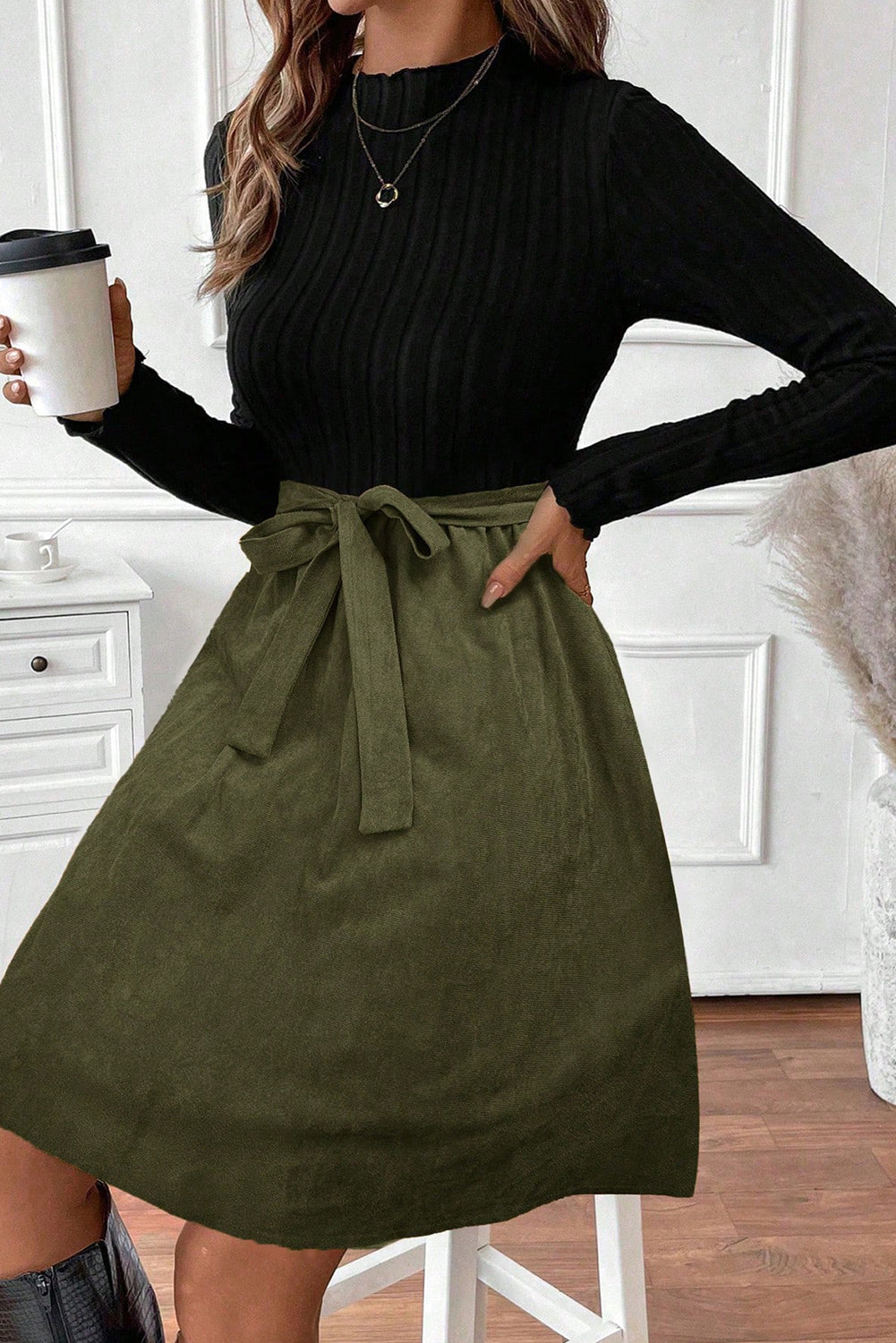Chic Women's Black Ribbed Knit Dress with Slim Fit Bodice, Flared Skirt, and Trendy Belted Accent